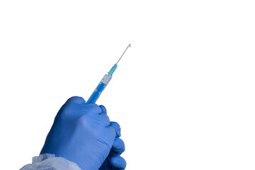 Hand holding a syringe with blue liquid ready for vaccination or medical procedure