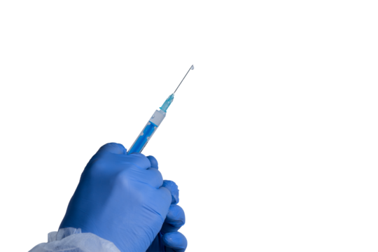 Hand holding a syringe with blue liquid ready for vaccination or medical procedure