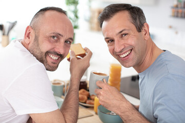 a couple have breakfast in the kitchen in sunny day
