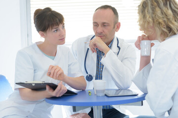 Fototapeta premium group of doctors looking at a clipboard