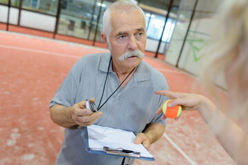 close up shot of a man teaching tennis