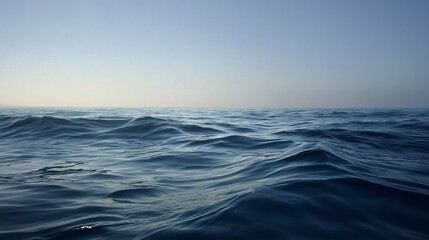 Fototapeta premium Endless expanse of ocean meets the pale horizon under the open sky.