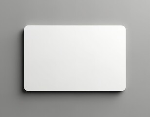 White gift card mockup on grey gradient background. Clean design offers versatile template for promotional material. Suitable for retail advertising, marketing campaigns. Simple layout presents