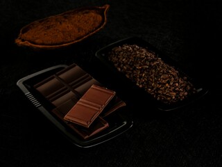 Artisanal chocolate sits elegantly on a black tray, surrounded by cacao beans and cocoa powder. The luxurious texture and deep color invite a sweet indulgence for chocolate lovers
