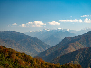 Naklejka premium Autumn mountains with a colorful slope in the foreground and another mountain in the background. 