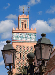 moroccan minaret with decorative tiles and street lamps, Marrakesch