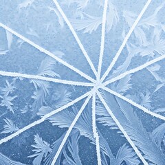 Close-up of a frozen window with ice crystals forming a radial pattern and intricate frost patterns.