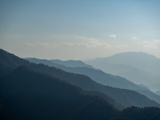 Fototapeta premium Silhouettes of a mountain range fading into the horizon. 