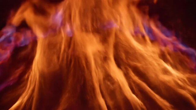 A captivating image shows the flames of a fire. The colors range from orange to purple