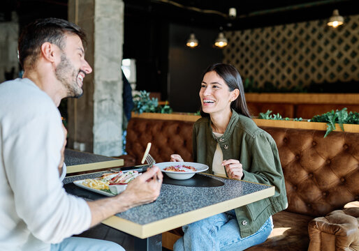 Portrait of ayoung romantic couple in restaurant having lunch - Powered by Adobe