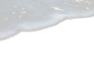 Texture of sea waves with white foam on a sandy beach, isolated transparent