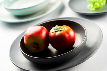 Still life with fake tomatoes and ceramic vessels