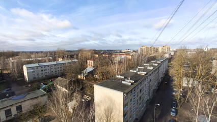 A tenth-floor view overlooks downtown streets with buildings and traffic below. The moment conveys scale, motion, and modern urban energy.