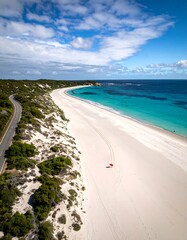 Scenic coastal beach with a road and dunes