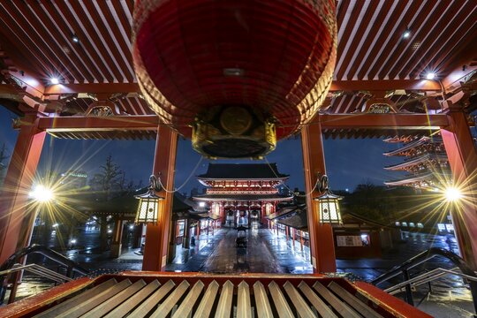 View from the main hall with a huge red lantern to the illuminated Hōzōmon Schazkammer Gate of Asakusa Shrine or Sensō-ji Temple, at night, Buddhist temple complex, Asakusa, Tokyo, Japan
