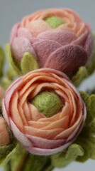 Fototapeta premium Soft Felt Ranunculus Flowers in Pastel Pink and Yellow, Handcrafted Floral Ornaments for Home Styling