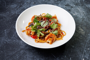 Spicy noodles with chicken, peppers, fresh herbs, and sesame seeds