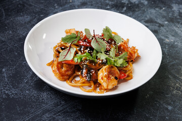 Spicy noodles with chicken, peppers, fresh herbs, and sesame seeds