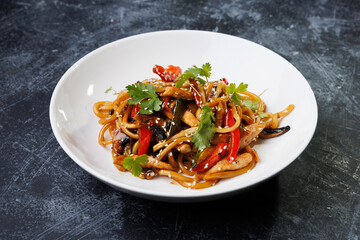 Spicy noodles with chicken, peppers, fresh herbs, and sesame seeds