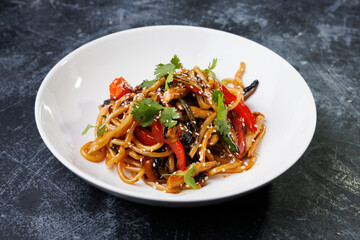 Spicy noodles with chicken, peppers, fresh herbs, and sesame seeds