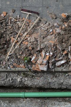 Newly laid green sewage pipe, trench, excavation, broom and pickaxe, Stuttgart, Baden-W&uuml;rttemberg