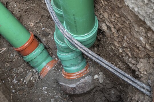 Construction worker, newly laid green sewage pipes, Stuttgart, Baden-W&uuml;rttemberg