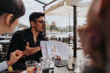 Colleagues collaborate and review financial data outdoors, fostering teamwork and discussion for future strategies. This highlights effective communication, teamwork, and professional engagement.
