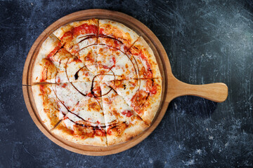 Cheesy Pepperoni Pizza Sliced On A Wooden Board With Tomato Sauce