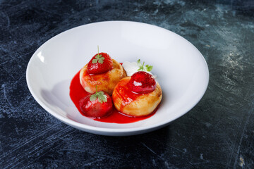 cottage cheese with strawberry red sauce in a white bowl