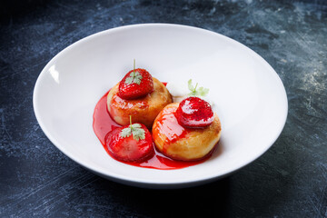 cottage cheese with strawberry red sauce in a white bowl