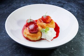 cottage cheese with strawberry red sauce in a white bowl