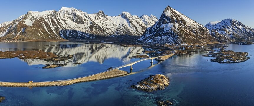 Aerial view of bridge, fjord, steep mountains, coast, winter, panorama, evening light, reflection, Moskenesoya, Lofoten, Norway