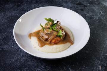 Gourmet Plate With Creamy Puree, Tender Meat, And Herb Garnish