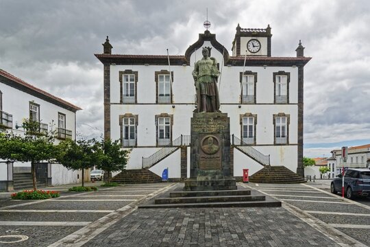 Town square with a statue in front of a historic building with clock tower Largo do Munic&iacute;pio de Vila Franca do Campo under a cloudy sky, small town Vila Franca do Campo, Sao Miguel, Azores, Portugal