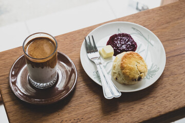 Dirty Coffee and scone on wood background