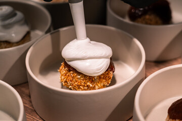 A bowl of food with a white frosting on top