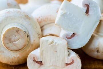 Close up of fresh white button mushrooms on a wooden surface