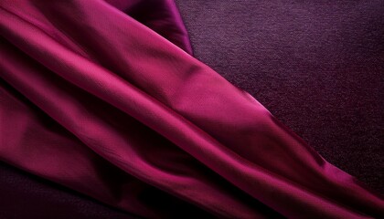 deep crimson fabric drapes over a dark textured background