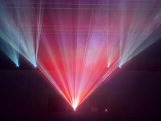 cinema projector with colored light beams that fan out from a central source, creating an intense and enveloping scenographic effect.