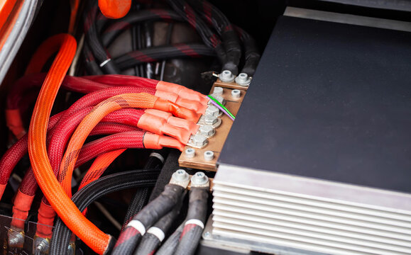 Closeup Of High-Current Power Cables For Automotive Sound System. Thick Red And Black Wires Connect To Distribution Block.