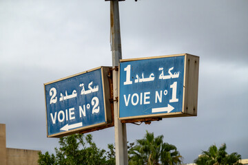 El Jem, Tunisia  A sign at  the  El Jem train station in French and Arabic says Track number one and Track number two.