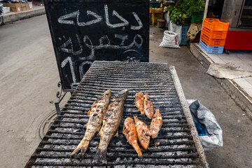 El Jem, Tunisia  Fish grilling on an outdoor grill in the souk or Medina.