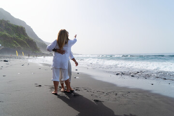 lifestyle of caucasian senior couple dance on beach, happy in love romantic and relax time, tourism of elderly family pleople, leisure and activity travel after retirement in vacations and summer
