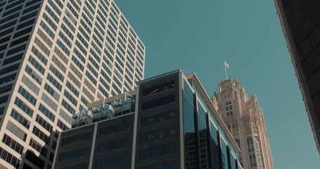 Looking up at city tower against colored sky, An artistic portrayal of city skyscraper with vibrant sky and reflective surfaces - Powered by Adobe