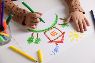 Cute little girl drawing with felt pen at white table, above view
