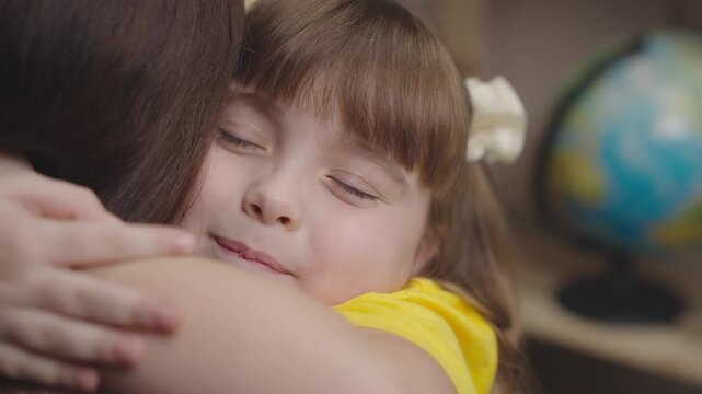little girl daughter hugs her beloved mother. happy family. childhood dream life. child education of a small kid family. childhood in mother's arms. baby daughter love mommy. parent patronize child.
