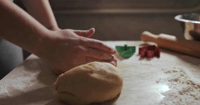 Housewife hands rolls dough with a rolling pin to make cookies. Video with audio.