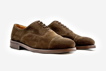 Classic leather shoes in a white background.  Classic brown suede shoe with texture.