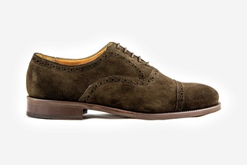 Classic leather shoes in a white background.  Classic brown suede shoe with texture.