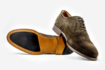 Classic leather shoes in a white background.  Classic brown suede shoe with texture.